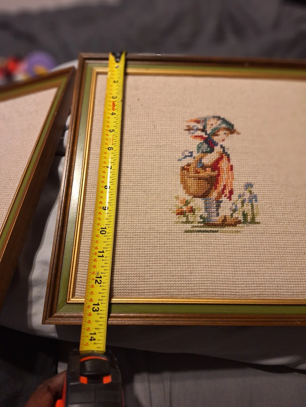 a pair of vintage Hummel framed needlepoint pictures featuring a boy a Girl